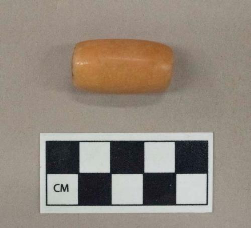 Ground stone bead, tubular, carnelian