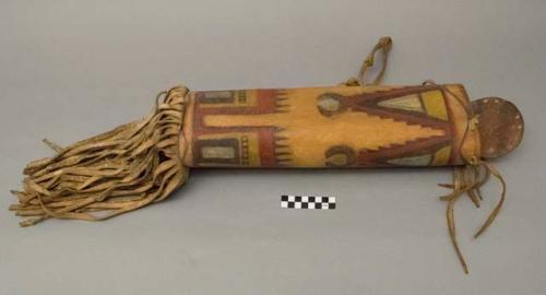 Cylindrical rawhide or parfleche, lidded container with leather fringe around bottom and one leather handle, geometric designs.