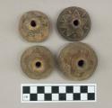 Terra cotta spindle whorls ornamented with incised lines