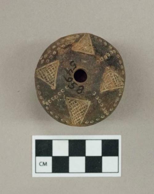 Terra cotta spindle whorls ornamented with incised lines