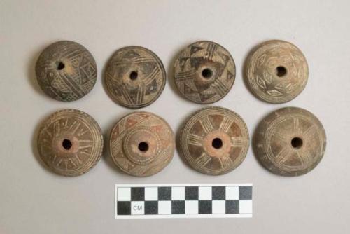 Ceramic spindle whorls, round, incised decoration