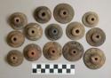 Terra cotta spindle whorls ornamented with incised lines