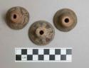 Ceramic spindle whorls, circular, incised decoration