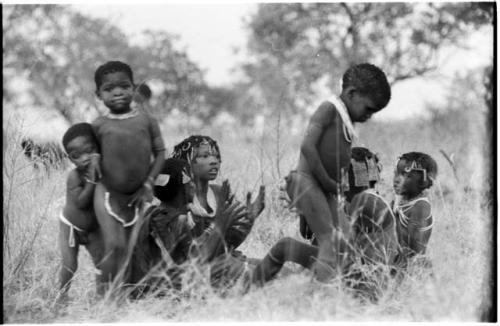 Girls clapping and singing and a boy dancing