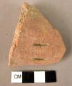 Potsherd with two incised gashes, red slipped, unburnished