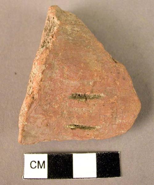 Potsherd with two incised gashes, red slipped, unburnished
