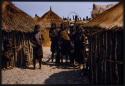 Group of women in the village of Sechekele, standing between huts