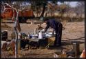 John Nambahu working in the kitchen at the expedition camp (out of focus)