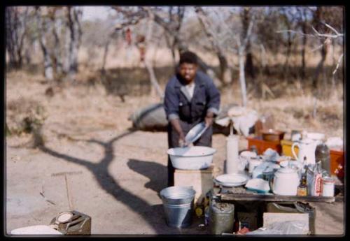 John Nambahu working in the kitchen at the expedition camp (out of focus)