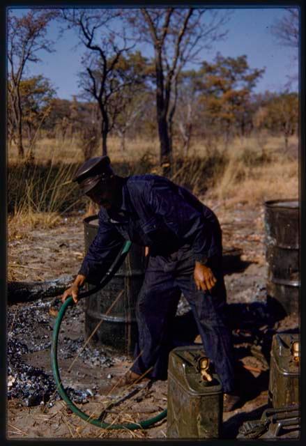 Paulus grabbing a water or gasoline hose