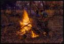 Boiling water drum on the fire, with a man standing next to it