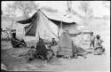 Group of Ju/'hoansi lying in front of one of the expedition tents