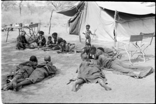 People lying in front of one of the expedition's tents