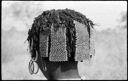 Back of N!ai's head showing beads and other hair accessories