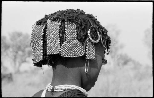 Back of N!ai's head showing beads and other hair accessories