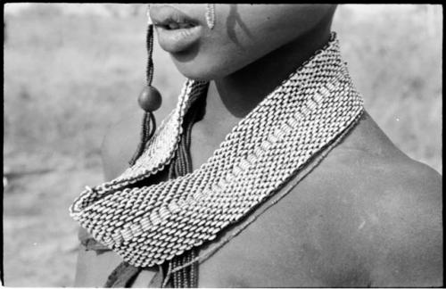 Close-up of ostrich eggshell bead headband worn by women