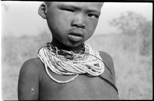 Headshot of /Gaishay (son of "Gao Medicine") wearing beaded necklaces