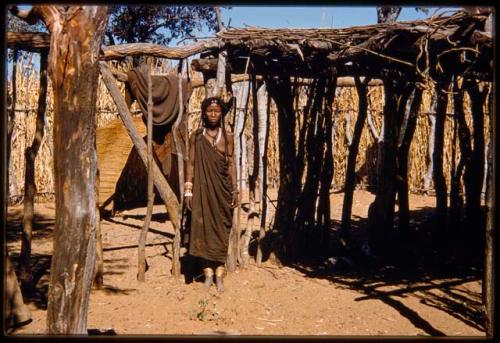 Woman standing next to a shade canopy