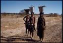 Women carrying buckets of water on their heads