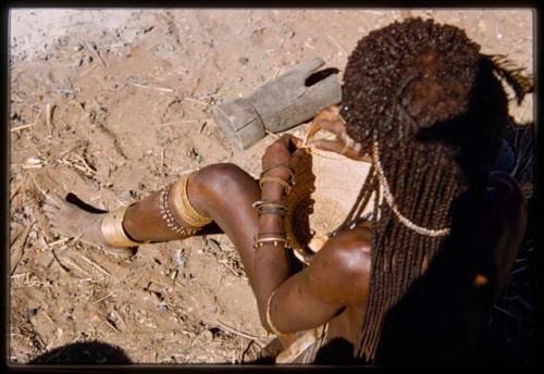 Woman making a basket, view from over her shoulder