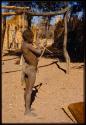 Boy standing and holding a bow and arrow