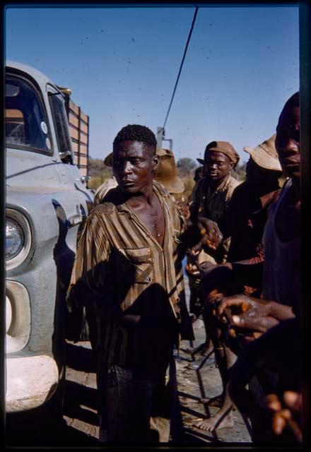 Men holding the cable on the pont (ferry) at Bagani