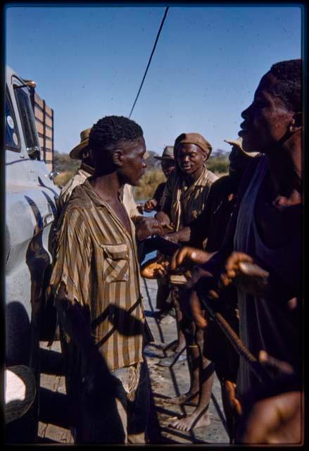 Men holding the cable on the pont (ferry) at Bagani