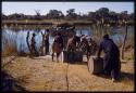 Men loading barrels on the pont (ferry) at Bagani