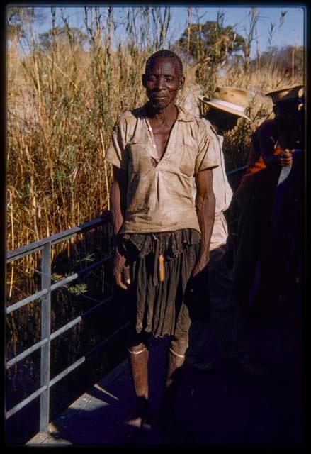 Man standing on the pont (ferry) at Bagani