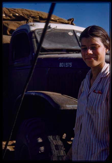 Deborah Marshall standing in front of the expedition truck on the pont (ferry) at Bagani