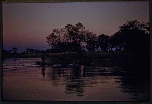 People poling mokoro (makoro) boats on the Cuito River