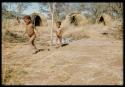 Children, Groups, play: Gao and !Nani (/Ti!kay's sons) walking in front of three skerms built for the rainy season