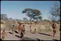 Children, Groups, play: Children playing a game at the foot of an anthill