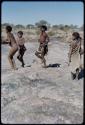 Children, Toys: Boys and girls dancing near a waterhole, including ≠Nisa (daughter of "Gao Medicine" and /Naoka) in the middle, and Be (daughter of Bo) to the right