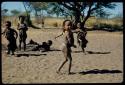 Children, Dancing: "Little ≠Gao" (foreground), Be behind him and //Kushay (daughter of /Qui and /Gasa) (right) playing in a dance circle area