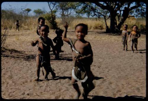 Children, Dancing: "Little ≠Gao" (foreground), Be (behind "Little ≠Gao") and //Kushay (daughter of /Qui and /Gasa) (right) playing in a dance circle area