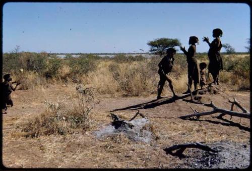 Children, Dancing: Children playing Tamah n!o’an (the ball game) on a termite mound, shows clapping with the fingers wide apart