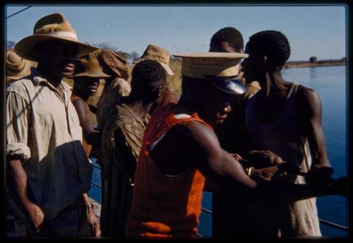 Men pulling cables on the pont (ferry) at Bagani