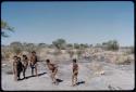 Children, Groups, play: Group of boys and girls dancing near a waterhole