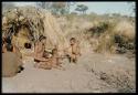 Children, Fathers and sons: /Gunda (son of "Old ≠Toma" and /Gam) playing with three young children of Band 2 in front of a skerm, including the daughter of //Ao and ≠Nisa and Xama (daughter of "Gao Helmet" and //Kushay)