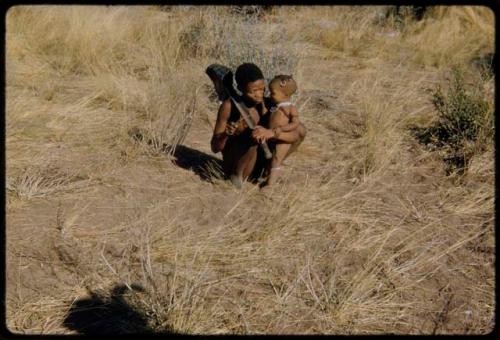 Children, Music: //Ao playing a one-stringed instrument and holding his daughter, Khuan//a