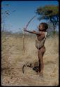 Children, Socialization--hunting, carrying: !Naishi (son of "/Qui Navel") holding a bow
