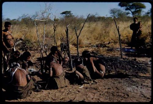 Fire, "Old ≠Toma's": People sitting near the remains of "Old ≠Toma's" skerm, burned to the ground