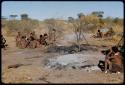 Fire, "Old ≠Toma's": People sitting near the remains of "Old ≠Toma's" skerm, burned to the ground, distant view