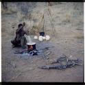 Food, Cooking: /Naoka (first wife of "Gao Medicine") cooking ostrich eggs in an Ovambo pot (half of stereo 2001.29.31906)