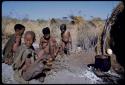 Food, Cooking: /Naoka preparing food, meat cooking in a pot, with her mother, "Old /Gasa" sitting in front of a skerm