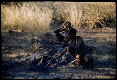 Food, Cooking: "Old /Gasa" cooking an animal head in coals and hot ashes in a covered pit