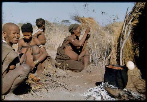 Food, Cooking: Woman smoking a pipe, sitting with /Naoka ("/Qui Hunter's" wife) and her mother "Old /Gasa"