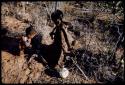 Food Gathering, Children: Woman sitting with a child next to her, an ostrich eggshell on the ground next to them