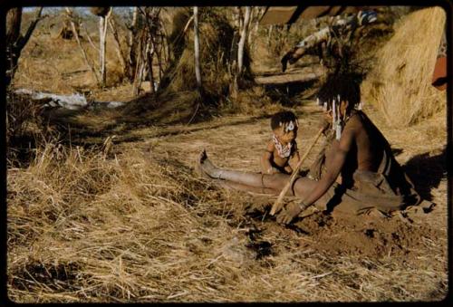 Food Gathering, Children: ≠Ghia of Band 10 digging for untjies near a skerm